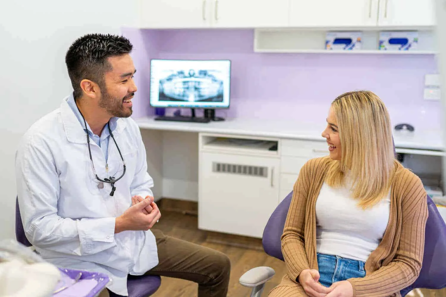 Dentist discussing Compassionate Release of Superannuation with a patient at Couture Implant Centre