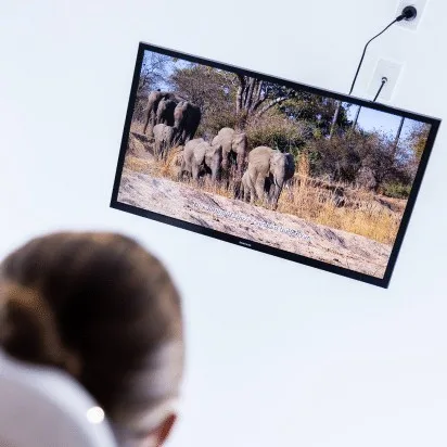 Ceiling-mounted TV for patient comfort at Couture Implant Centre