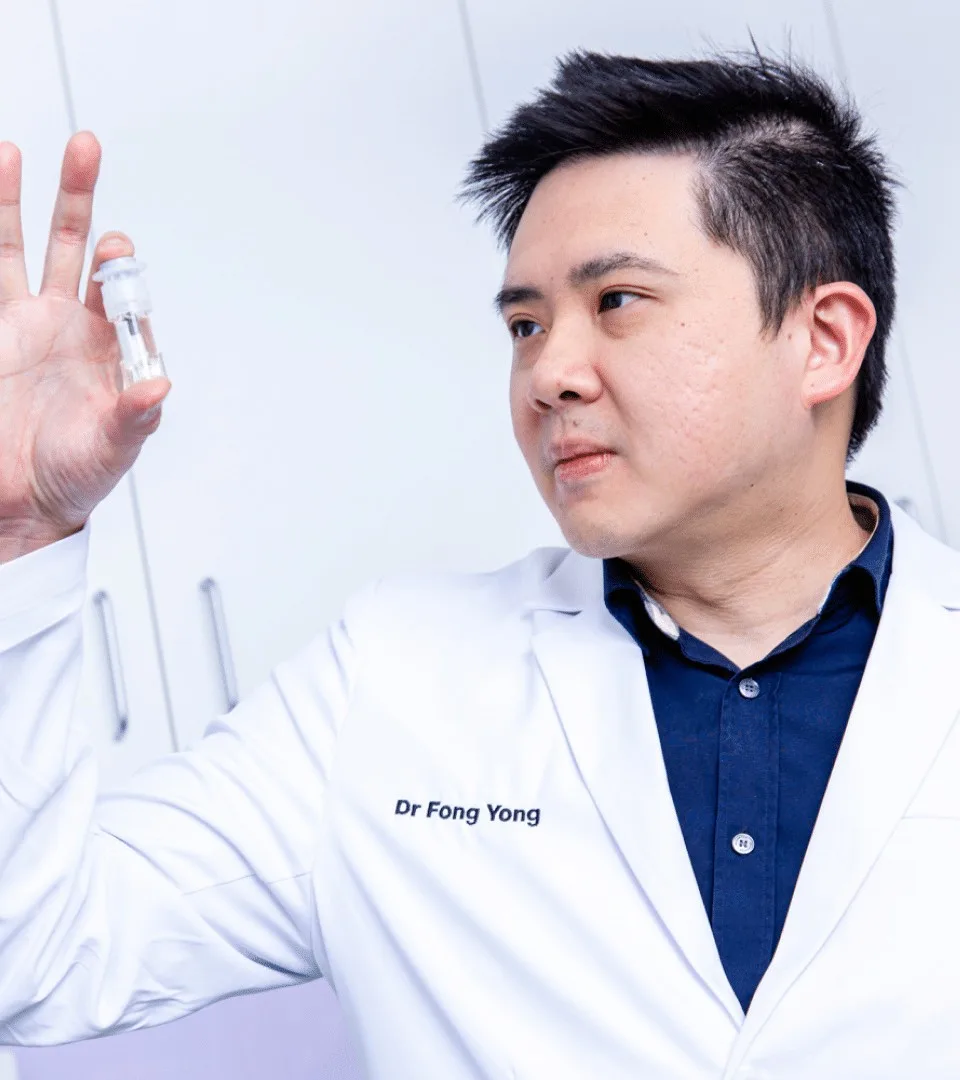 Dr Fong holding an All-On-4 Plus implant